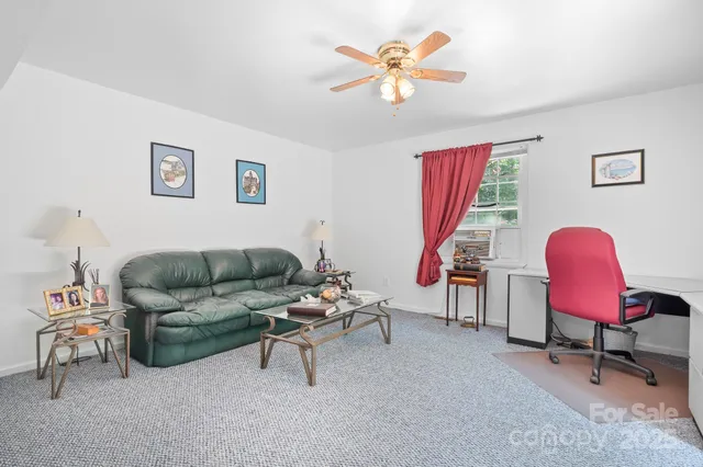 a living room with furniture and a chair