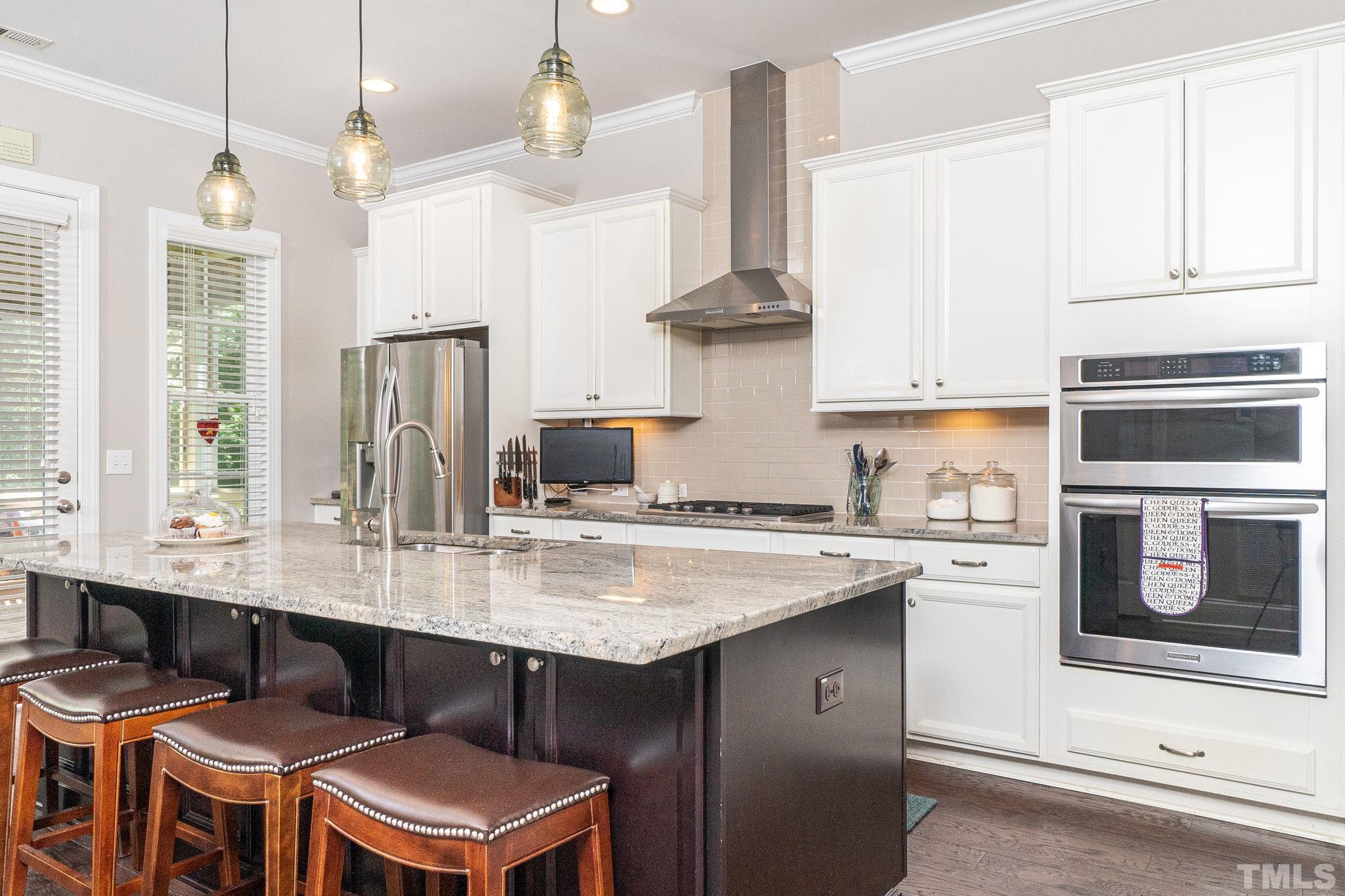 129 Penley Circle Raleigh, NC 27609 - Photo 15 of 43 a kitchen with stainless steel appliances a sink a stove a refrigerator and cabinets