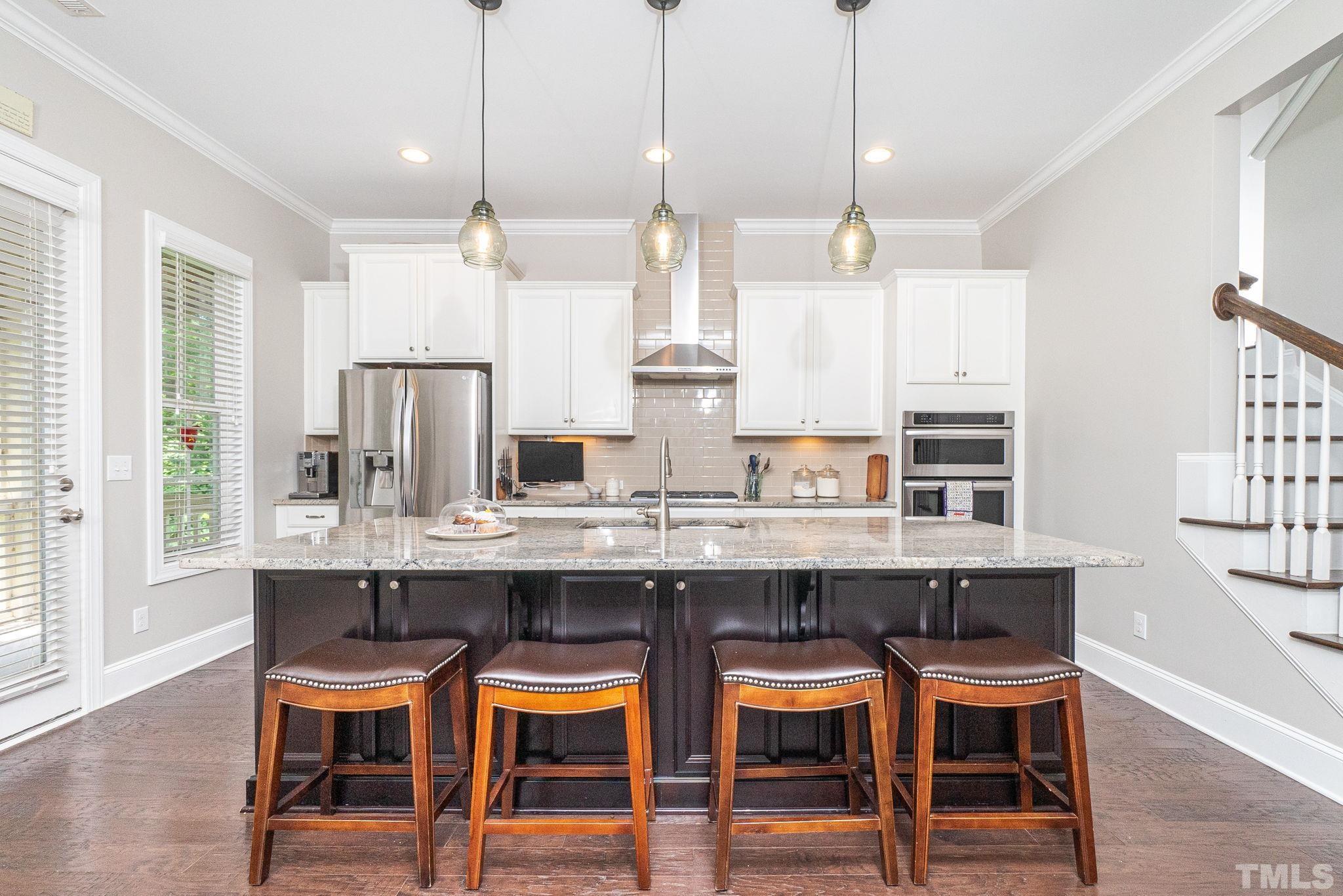 129 Penley Circle Raleigh, NC 27609 - Photo 16 of 43 a kitchen with kitchen island cabinets and chairs in it