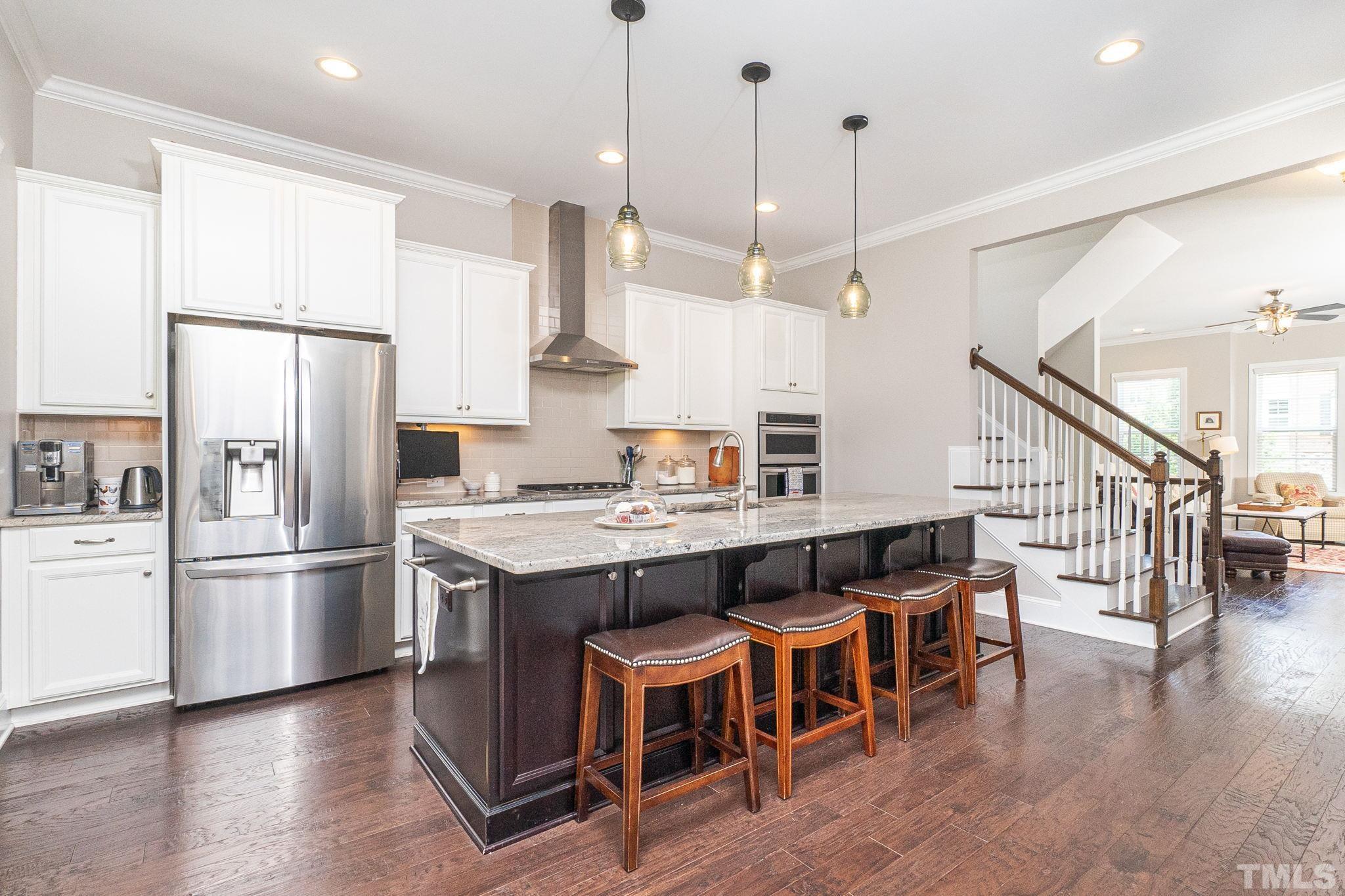 129 Penley Circle Raleigh, NC 27609 - Photo 18 of 43 a kitchen with stainless steel appliances granite countertop a refrigerator a stove a sink and a refrigerator