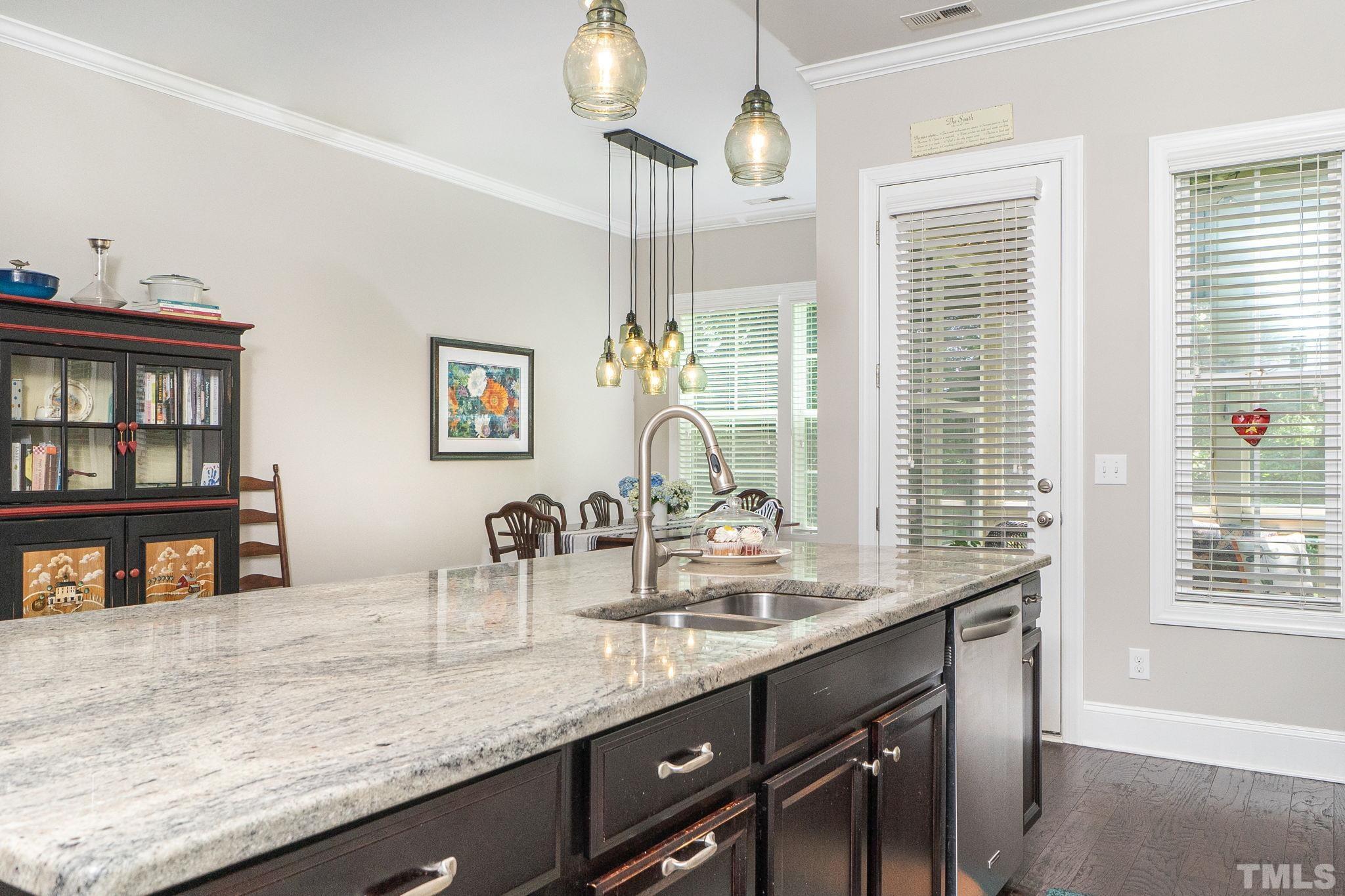 129 Penley Circle Raleigh, NC 27609 - Photo 21 of 43 a dining hall with stainless steel appliances granite countertop a sink and a large window