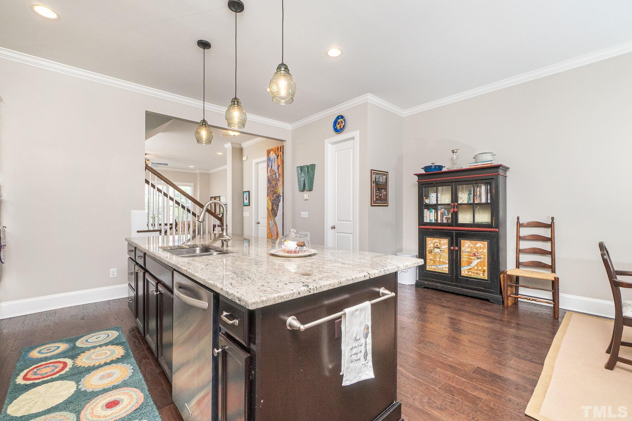 129 Penley Circle Raleigh, NC 27609 - Photo 22 of 43 a kitchen with a table chairs and wooden floor
