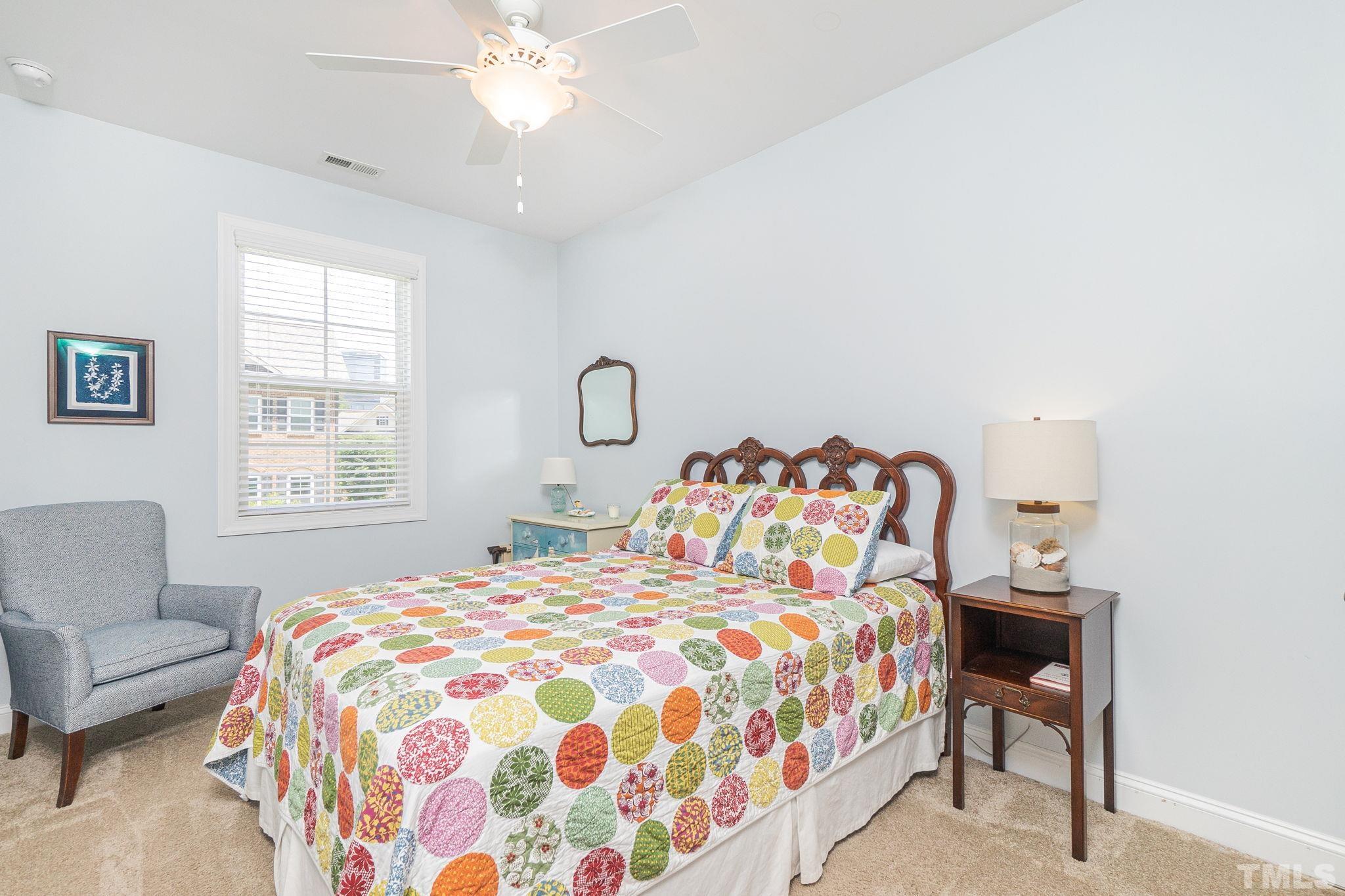 129 Penley Circle Raleigh, NC 27609 - Photo 27 of 43 a bedroom with a bed and a couch