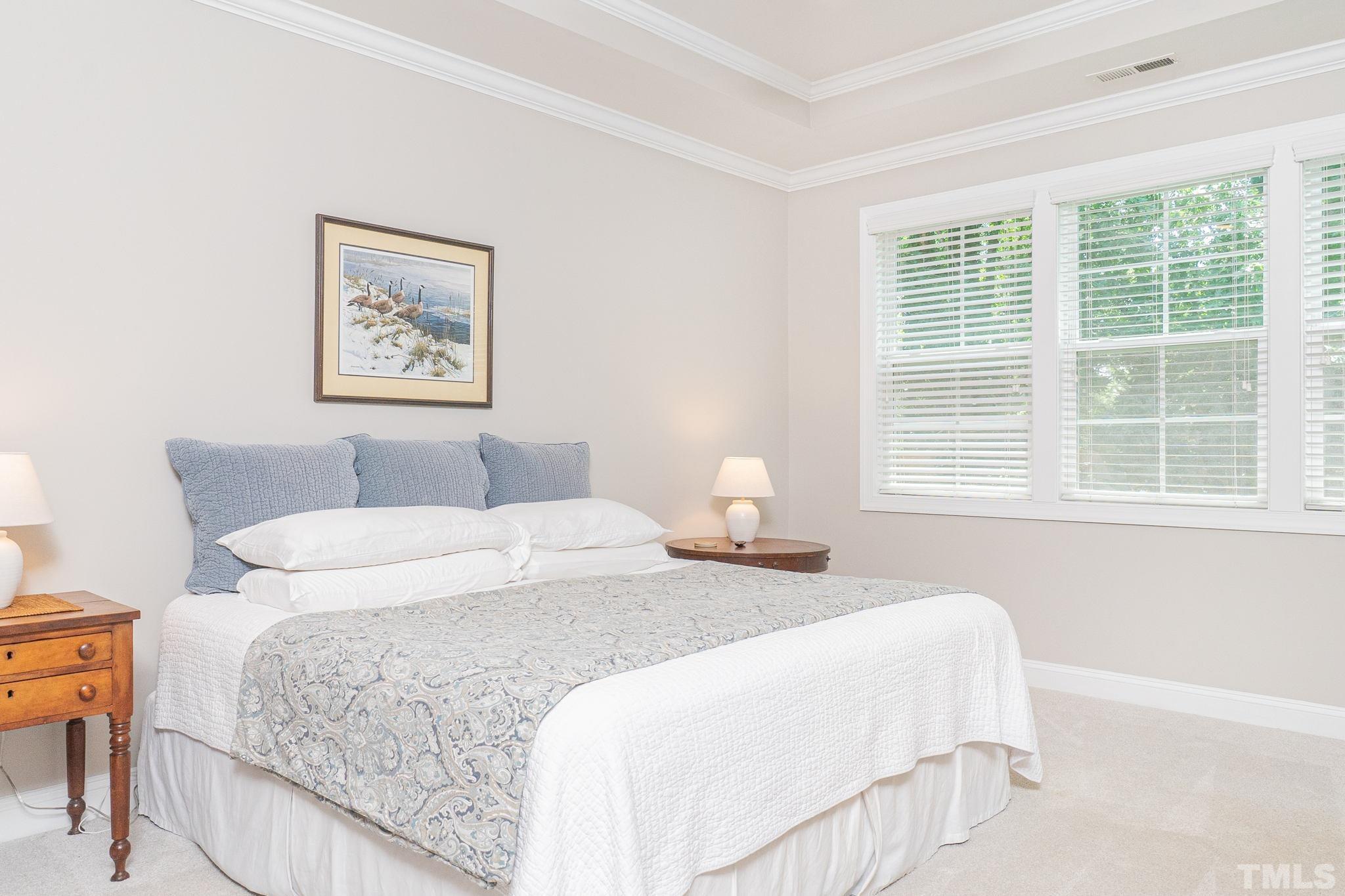129 Penley Circle Raleigh, NC 27609 - Photo 30 of 43 a bedroom with a bed and a window