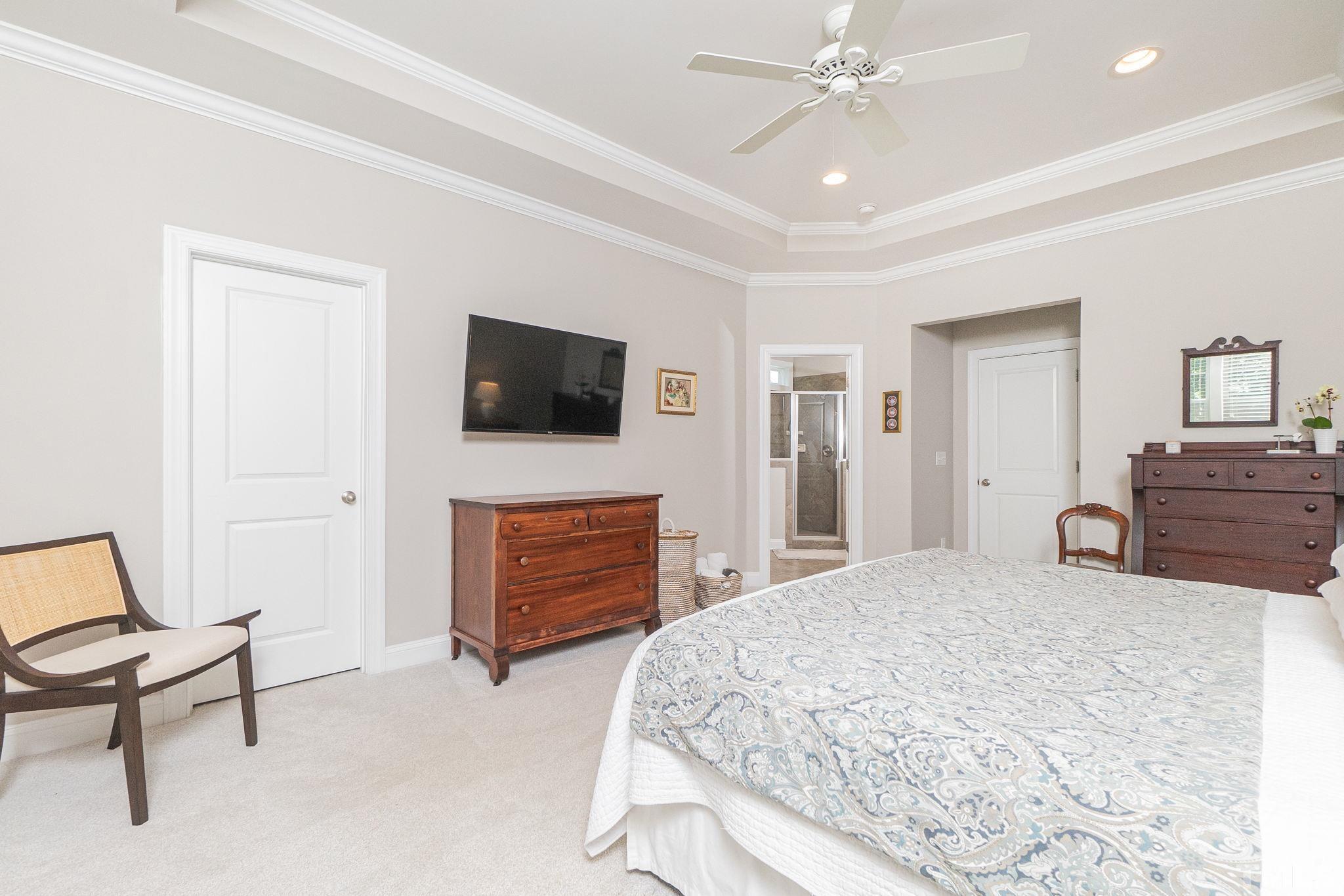 129 Penley Circle Raleigh, NC 27609 - Photo 32 of 43 a bedroom with a bed and a flat screen tv