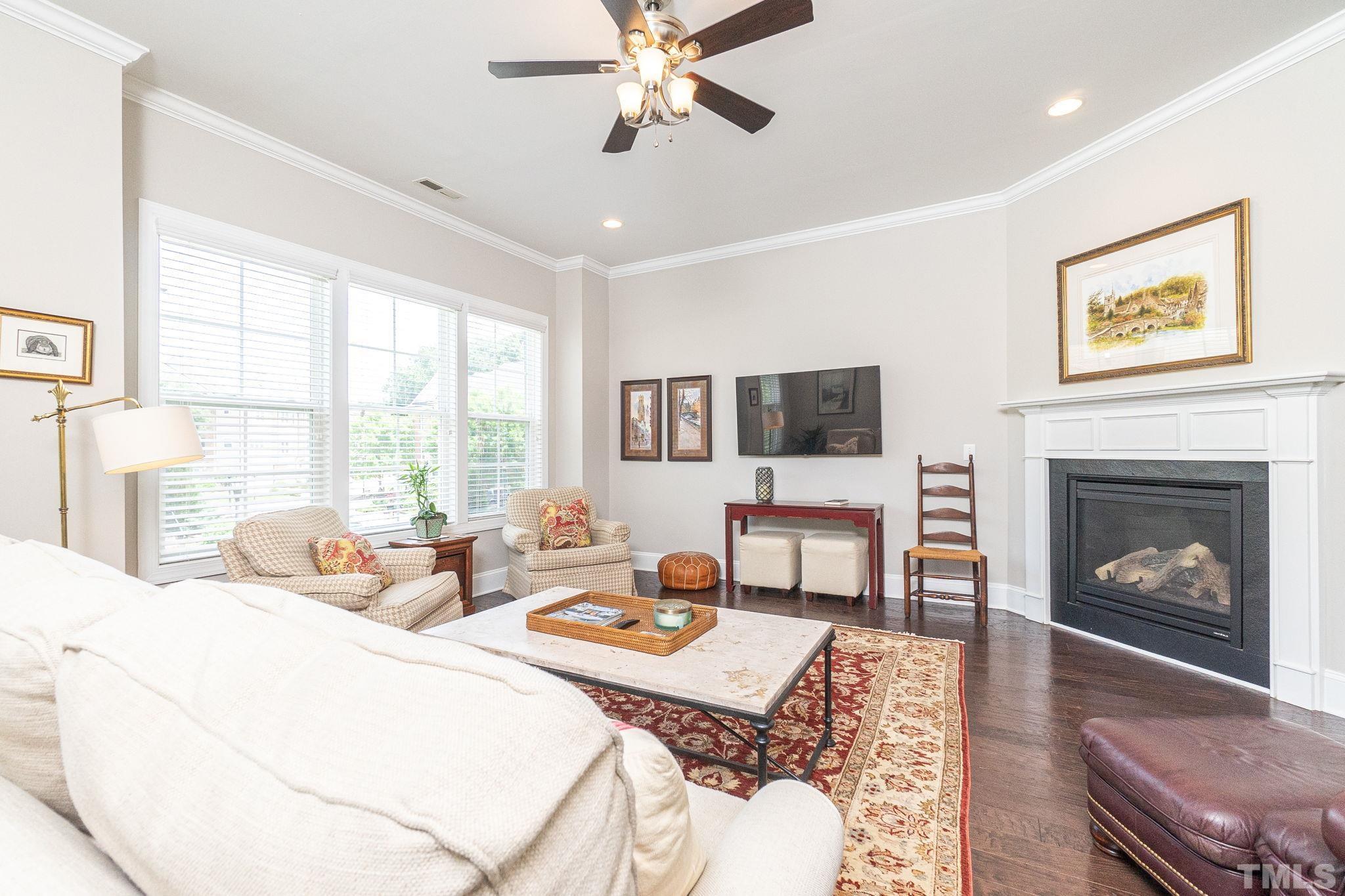129 Penley Circle Raleigh, NC 27609 - Photo 8 of 43 a living room with furniture a fireplace and a flat screen tv