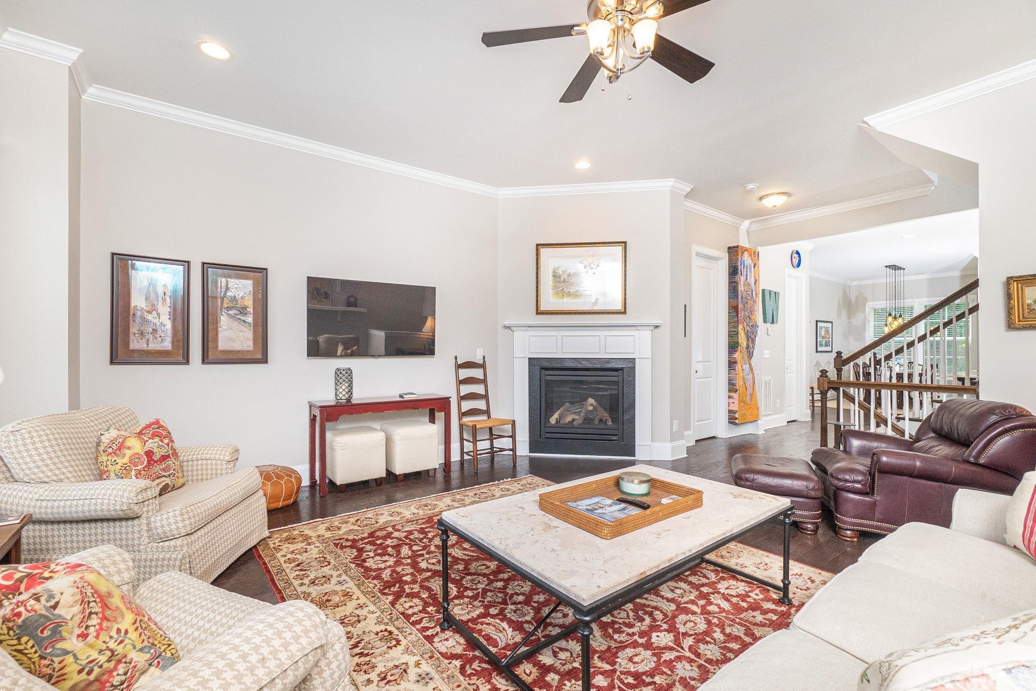 129 Penley Circle Raleigh, NC 27609 - Photo 10 of 43 a living room with furniture a rug and a flat screen tv