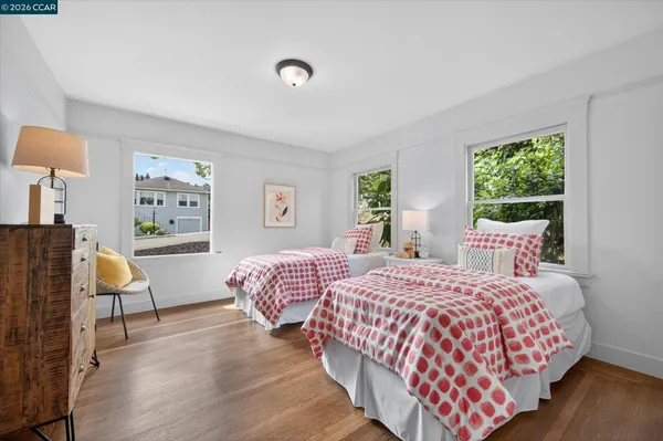 a bedroom with a bed wooden floor and window