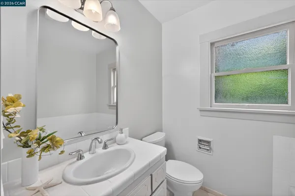 a bathroom with a sink toilet and mirror