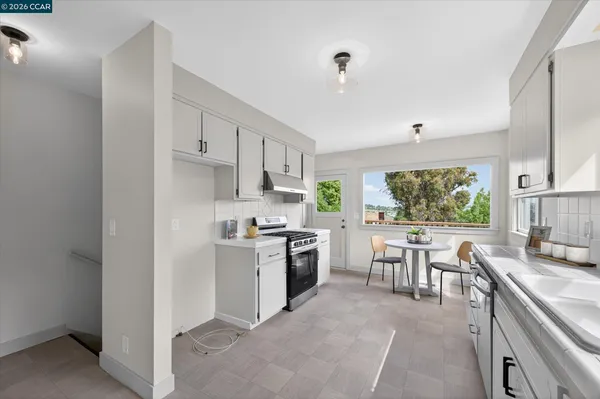 a kitchen with kitchen island granite countertop lots of counter top space and stainless steel appliances