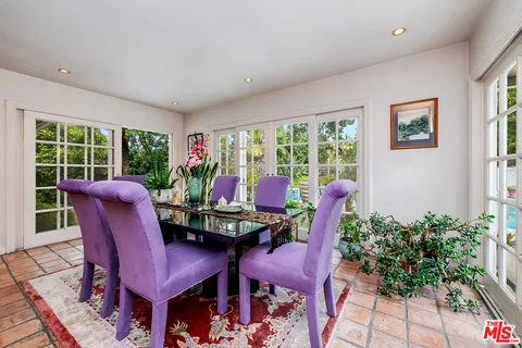 a balcony with table and chairs