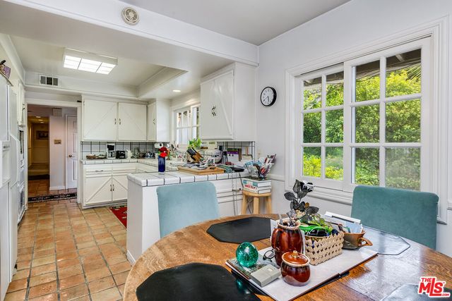 a kitchen with a white cabinets and white appliances