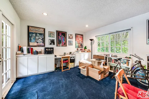 a living room with furniture and a floor to ceiling window