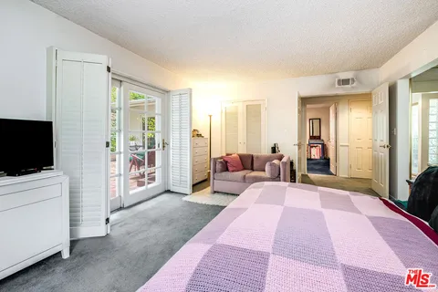 a large hall with stainless steel appliances granite countertop a sink and dishwasher