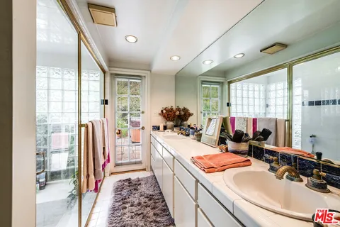 a backyard of a house with lots of green space and fountain