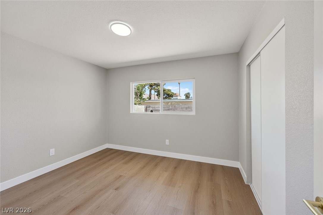 2484 Anglia Street Las Vegas, NV 89142 - Photo 17 of 20 This bright bedroom features a window offering views and durable wood flooring.