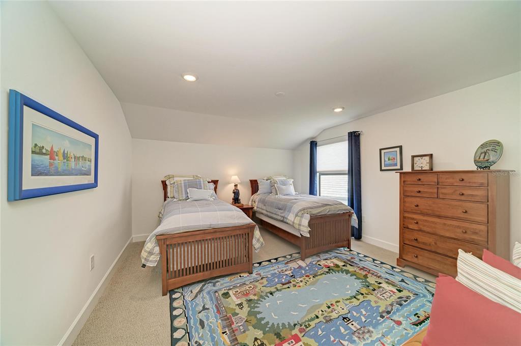 16341 Hidden Oak Loop Lakewood Ranch, FL 34211 - Photo 49 of 76 a bedroom with a bed and a dresser