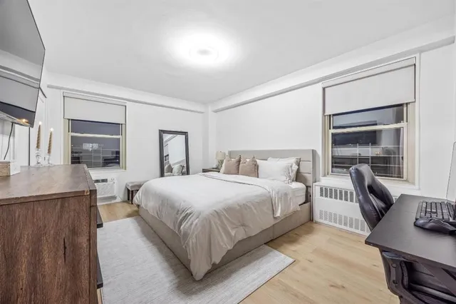 a bedroom with a bed and a desk