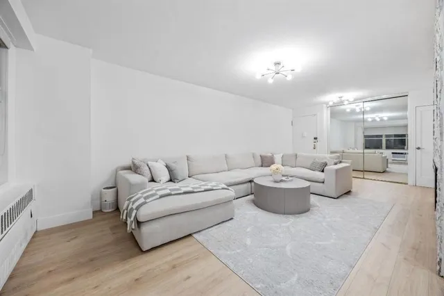 a living room with furniture and white walls