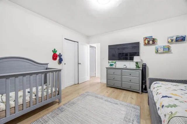 a bedroom with furniture and a baby crib