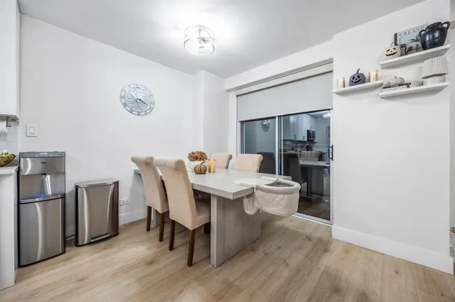 a view of a dining room with furniture wooden floor and a chandelier