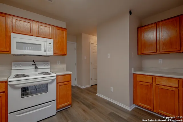 a kitchen with a stove microwave and sink
