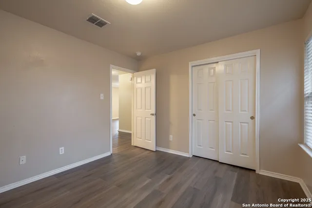 a view of an empty room and wooden floor