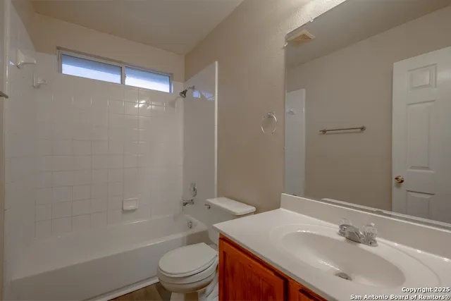 a bathroom with a sink toilet vanity and shower
