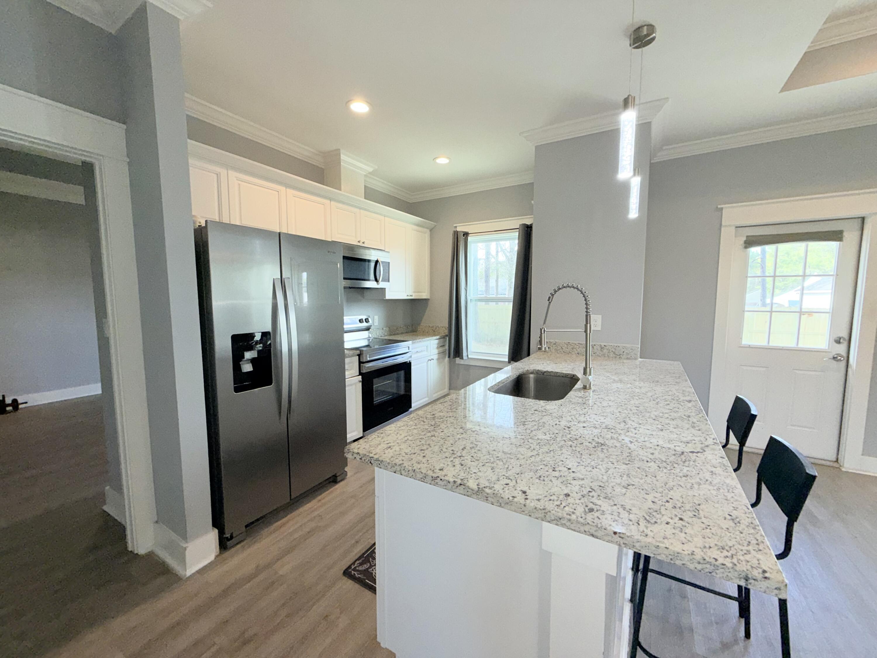 122 Loblolly Circle Midway, FL 32343 - Photo 12 of 38 a kitchen with stainless steel appliances granite countertop a sink and a refrigerator