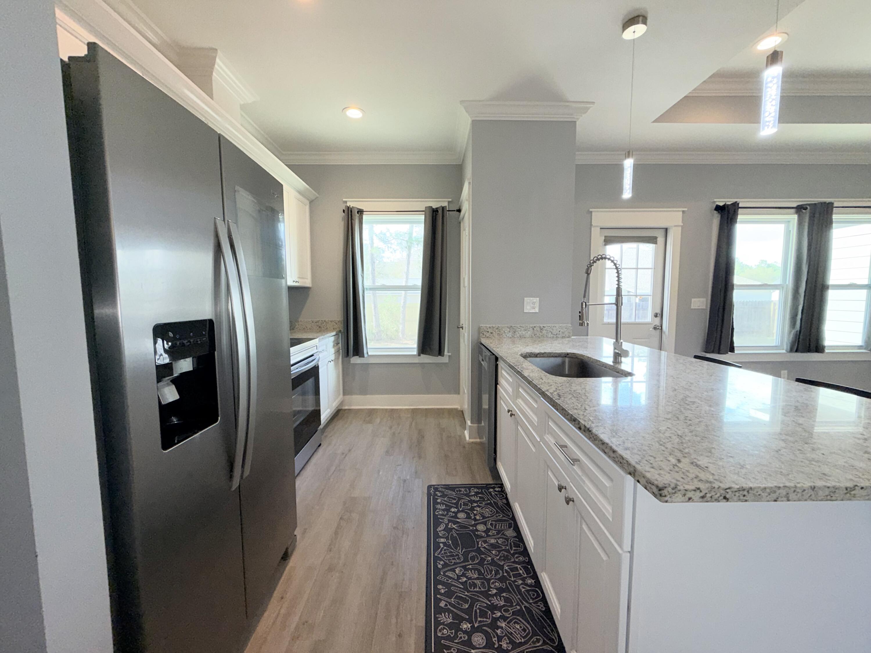 122 Loblolly Circle Midway, FL 32343 - Photo 13 of 38 a kitchen with stainless steel appliances granite countertop a refrigerator a sink and dishwasher