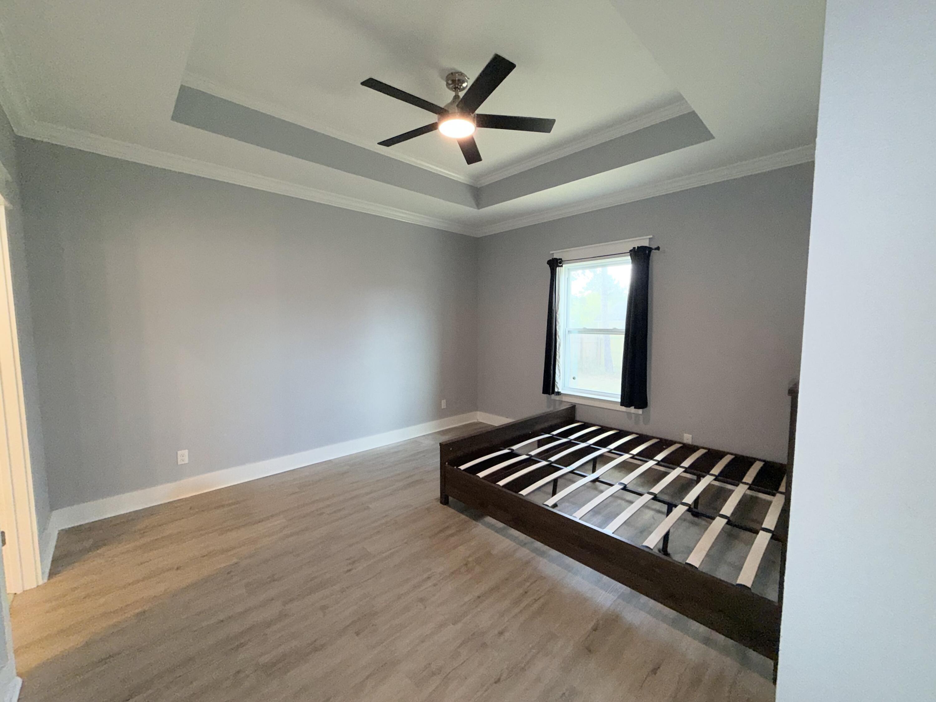 122 Loblolly Circle Midway, FL 32343 - Photo 18 of 38 wooden floor in an empty room with a window
