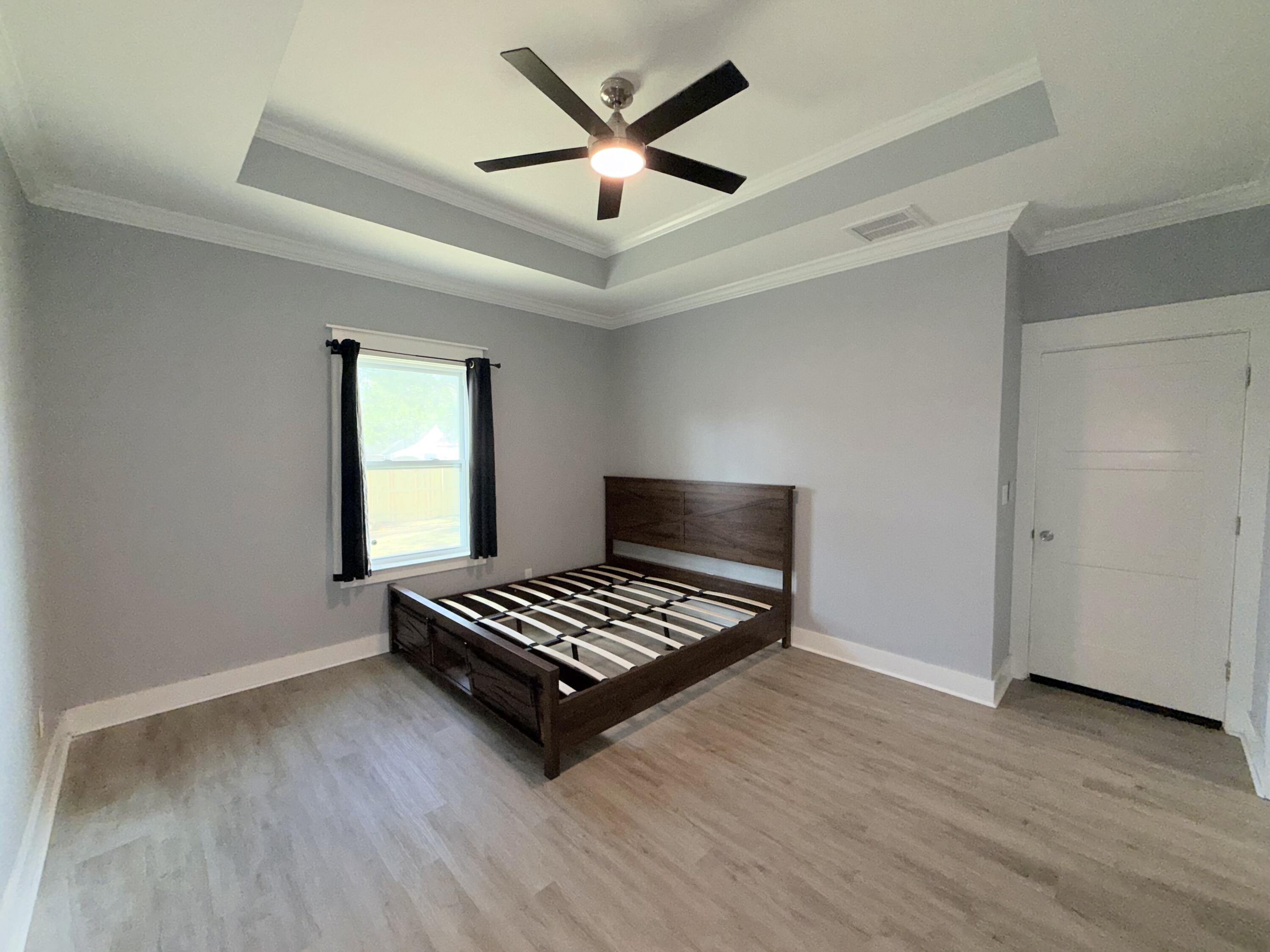 122 Loblolly Circle Midway, FL 32343 - Photo 19 of 38 a view of wooden floor and a chandelier fan in a room