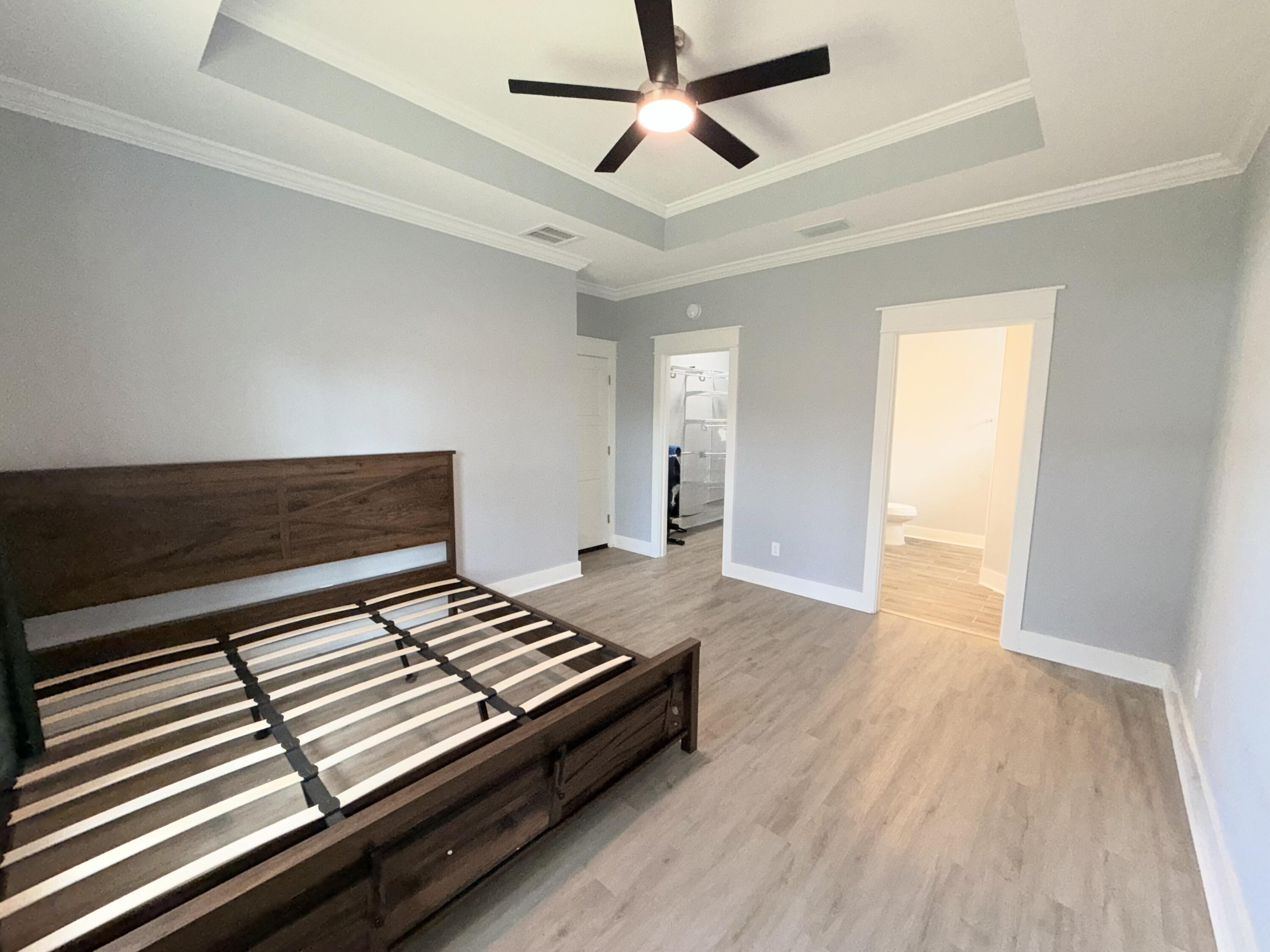 122 Loblolly Circle Midway, FL 32343 - Photo 20 of 38 a bedroom with wooden floor closet and a ceiling fan