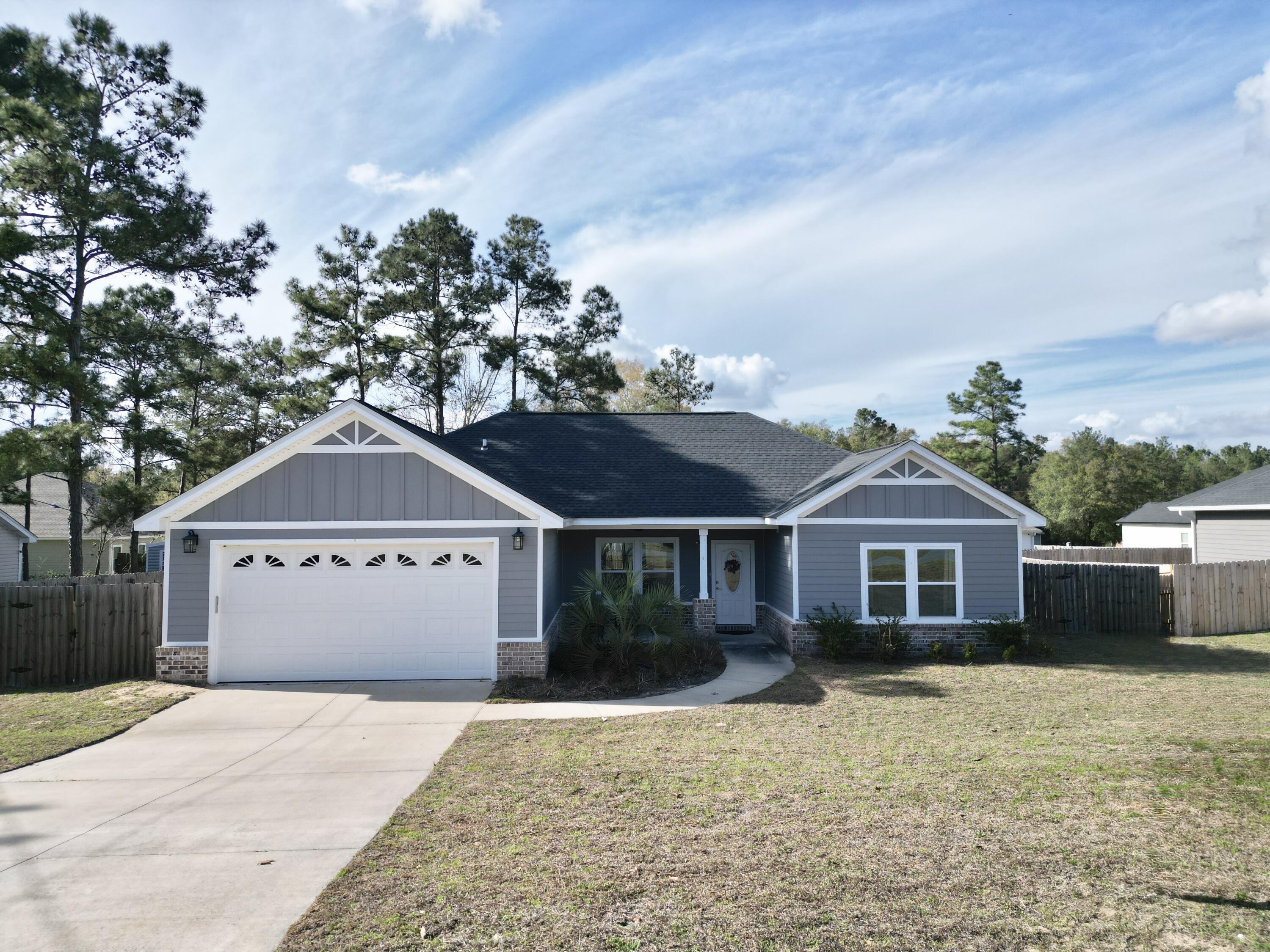 122 Loblolly Circle Midway, FL 32343 - Photo 2 of 38 a front view of a house with a garden