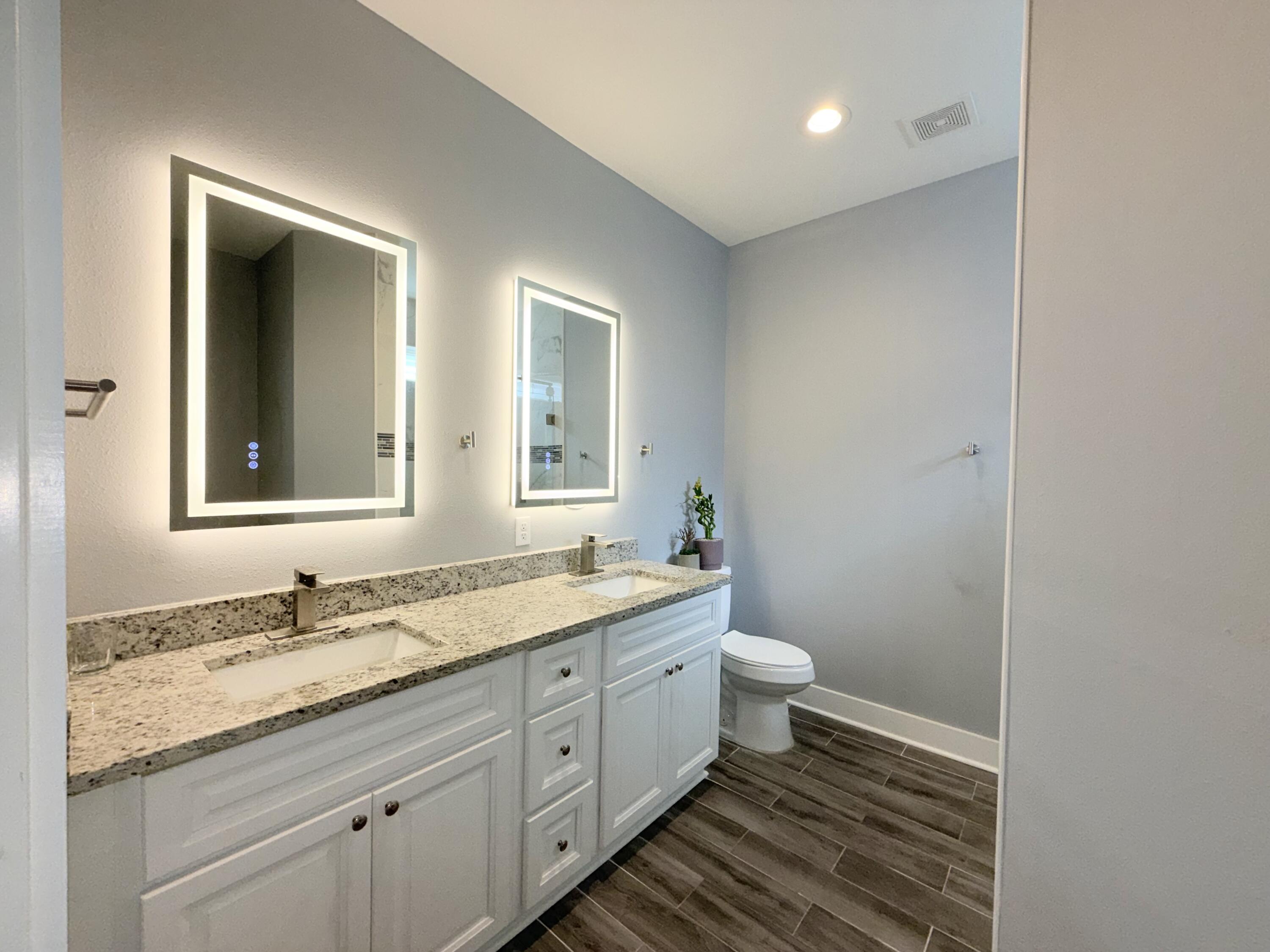 122 Loblolly Circle Midway, FL 32343 - Photo 21 of 38 a bathroom with a granite countertop sink a toilet and a mirror
