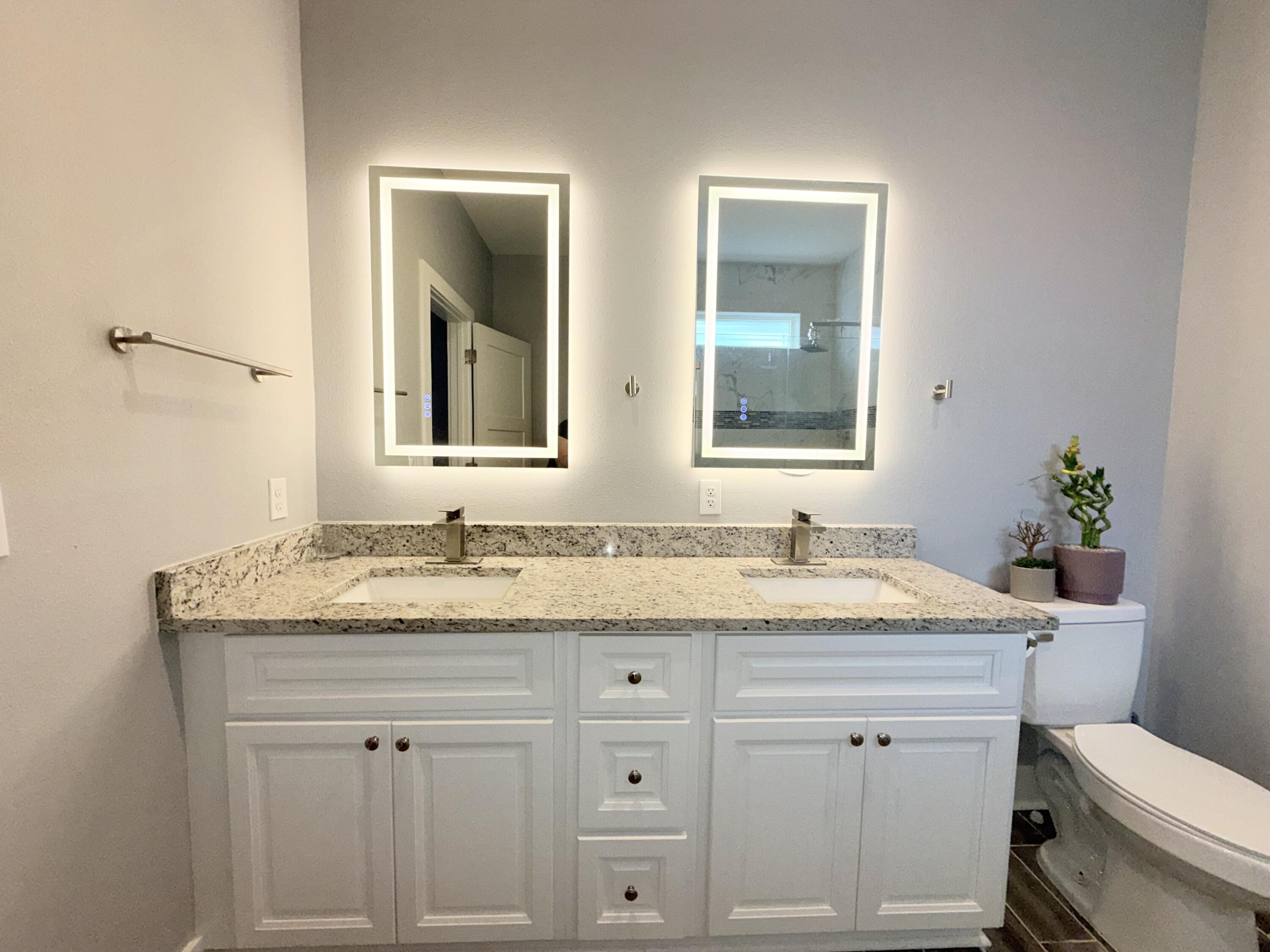 122 Loblolly Circle Midway, FL 32343 - Photo 22 of 38 a bathroom with a granite countertop sink toilet and mirror