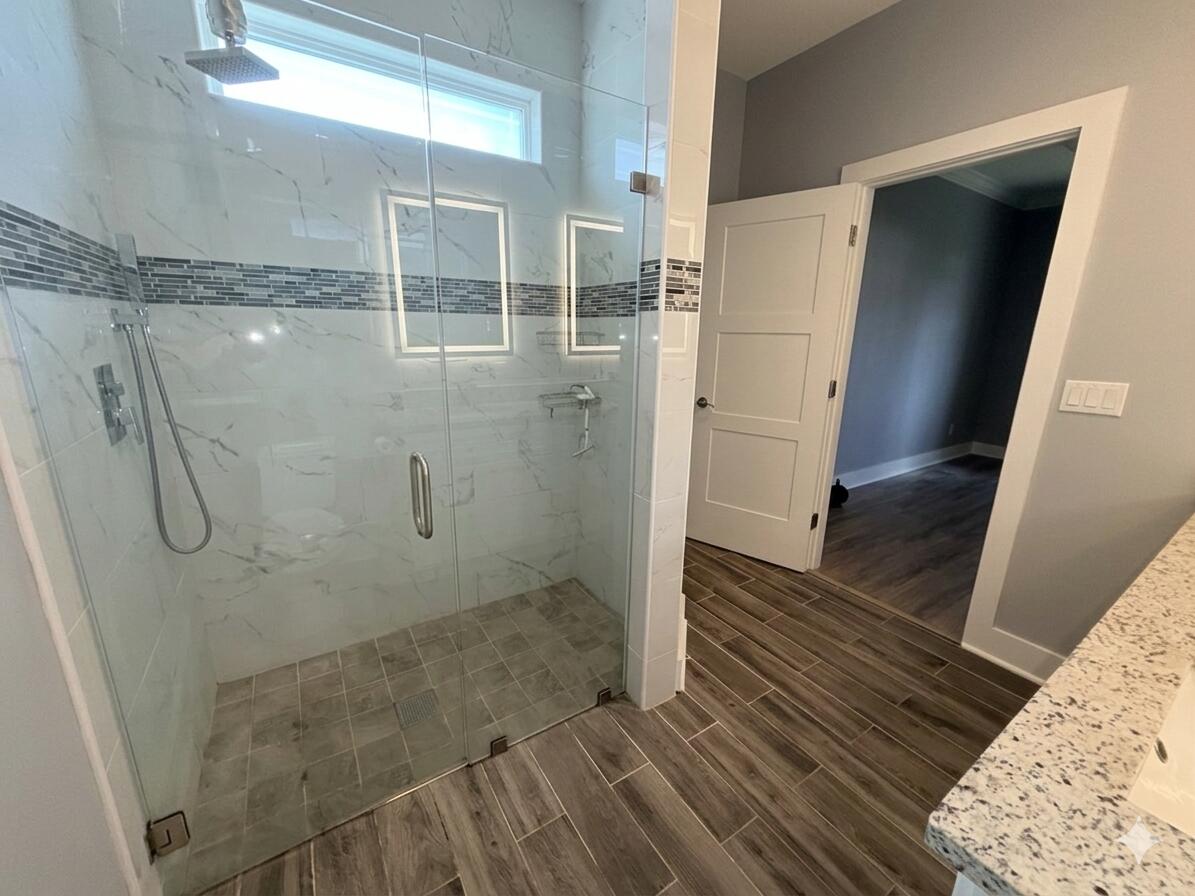 122 Loblolly Circle Midway, FL 32343 - Photo 23 of 38 a bathroom with a glass shower door