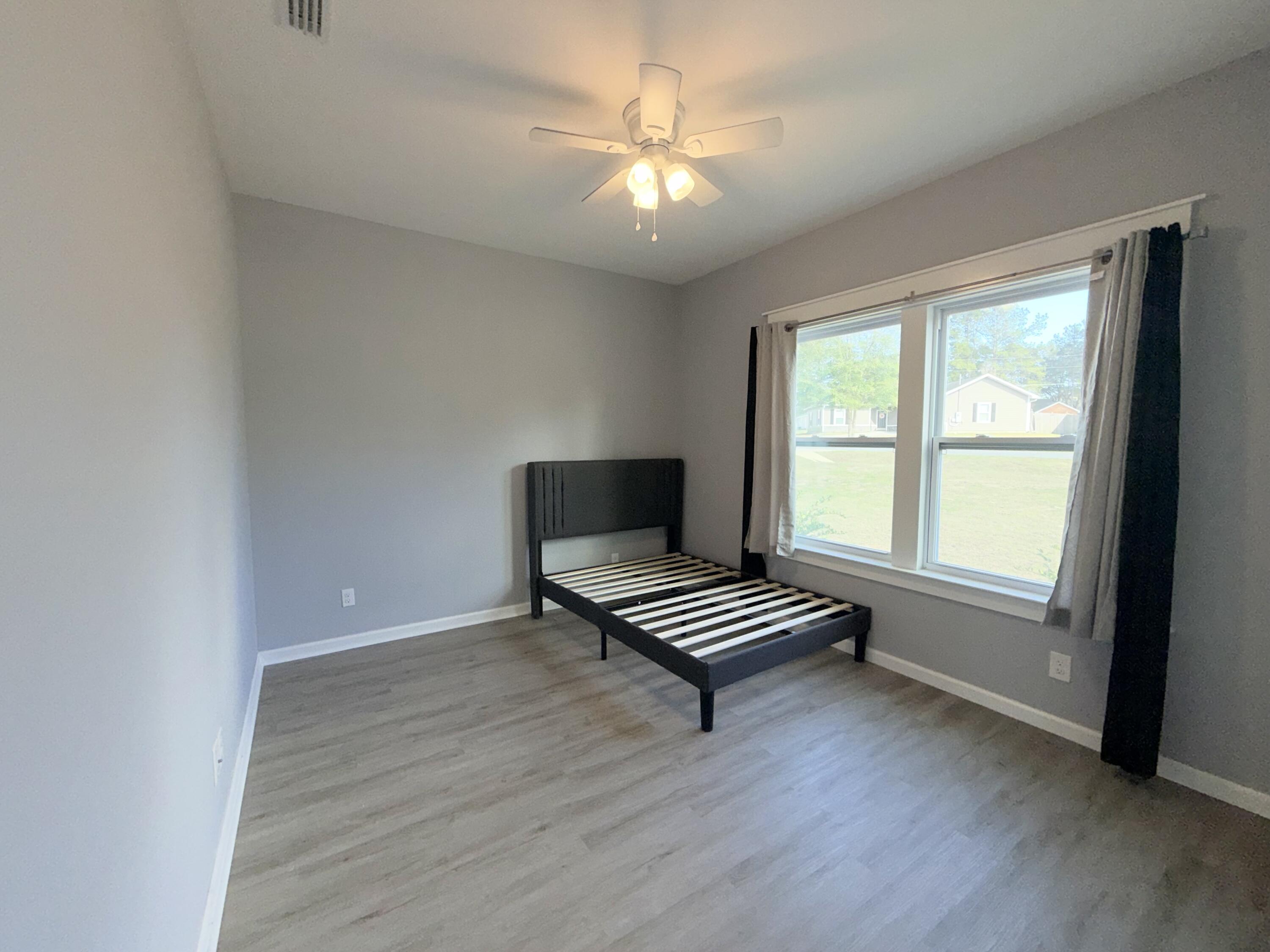 122 Loblolly Circle Midway, FL 32343 - Photo 26 of 38 an empty room with wooden floor and piano