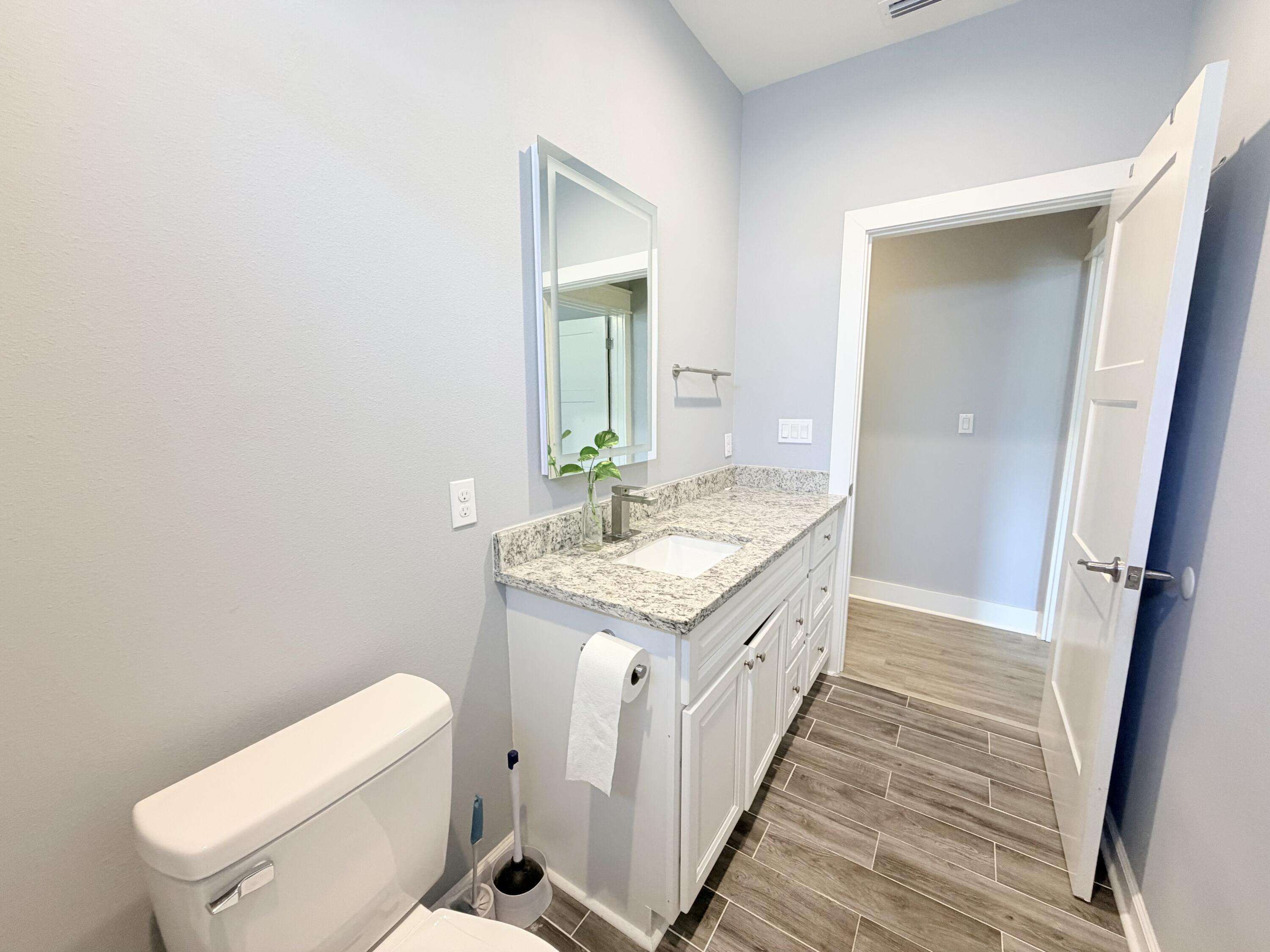 122 Loblolly Circle Midway, FL 32343 - Photo 30 of 38 a spacious bathroom with a granite countertop sink and a mirror