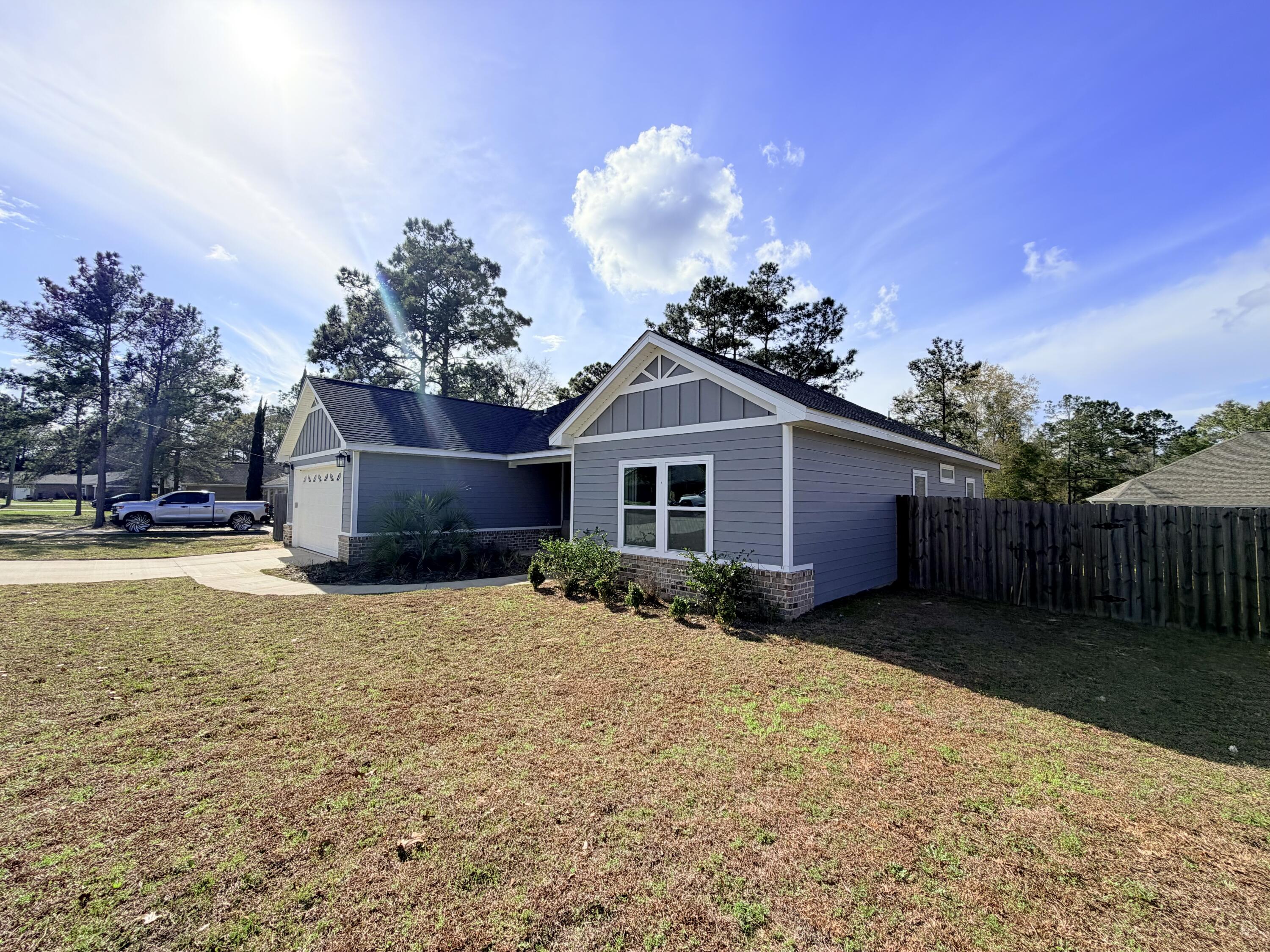 122 Loblolly Circle Midway, FL 32343 - Photo 3 of 38 a front view of house with yard and trees around