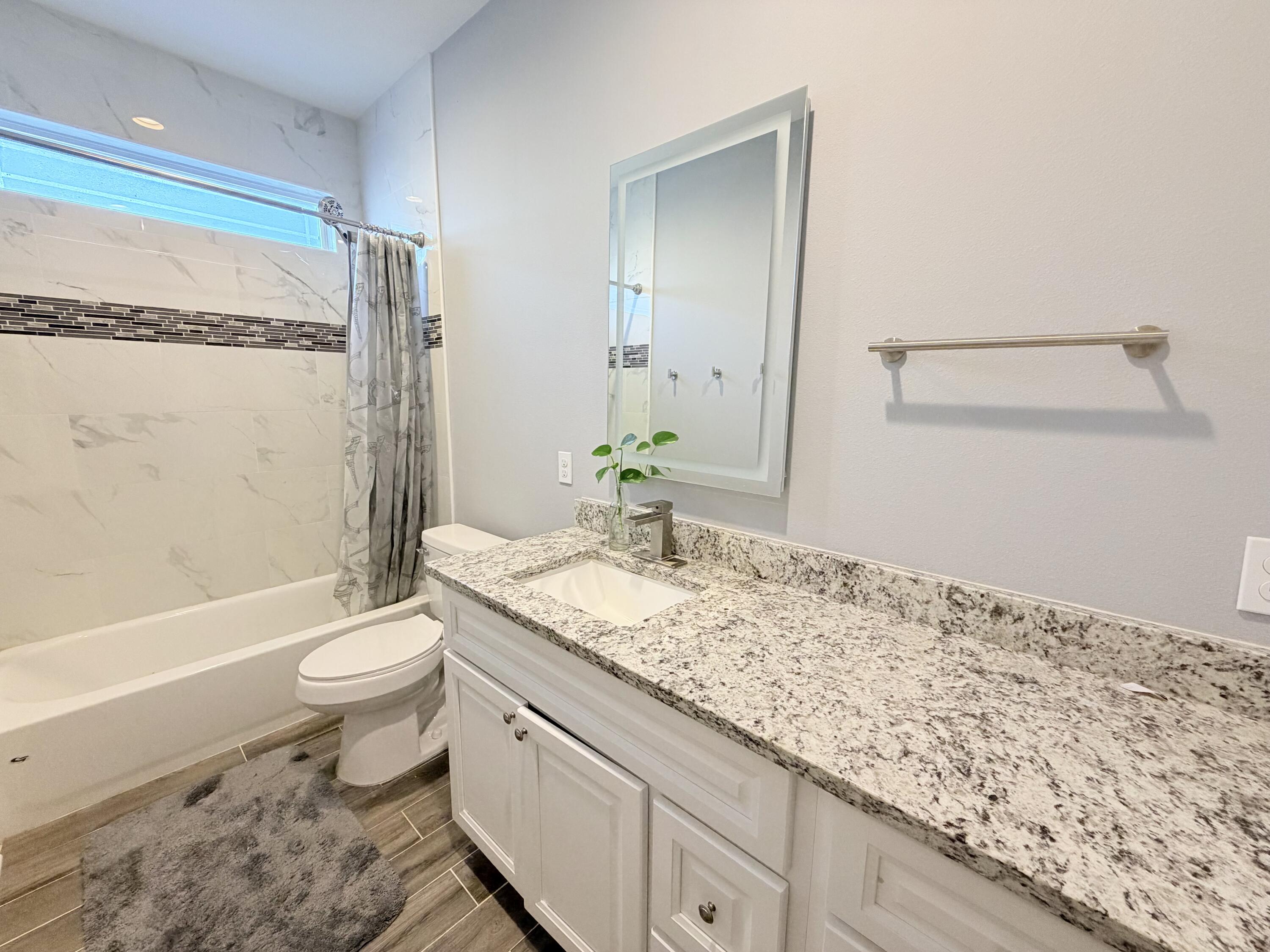 122 Loblolly Circle Midway, FL 32343 - Photo 34 of 38 a bathroom with a granite countertop sink toilet and shower