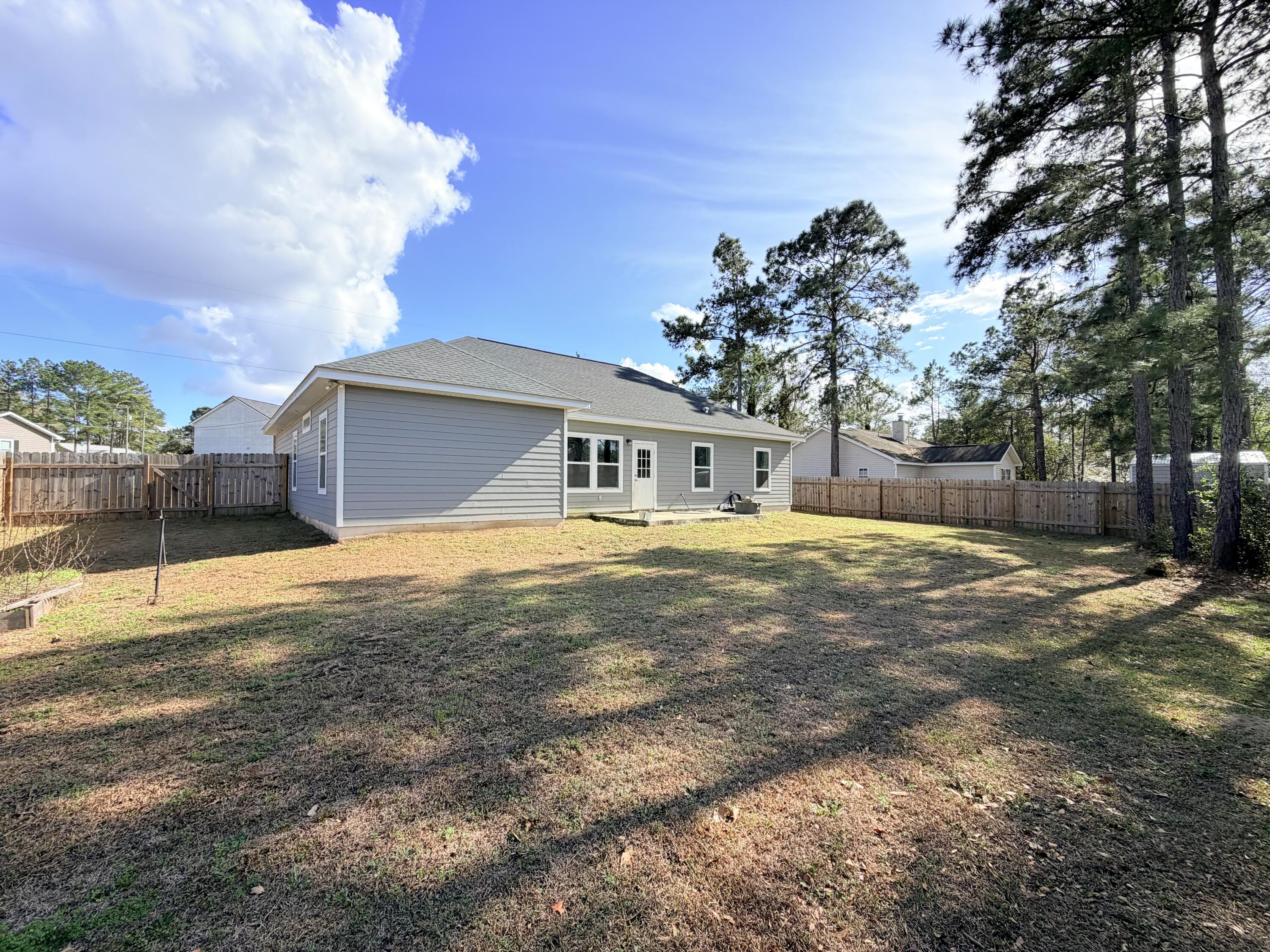 122 Loblolly Circle Midway, FL 32343 - Photo 35 of 38 a house with trees in front of it
