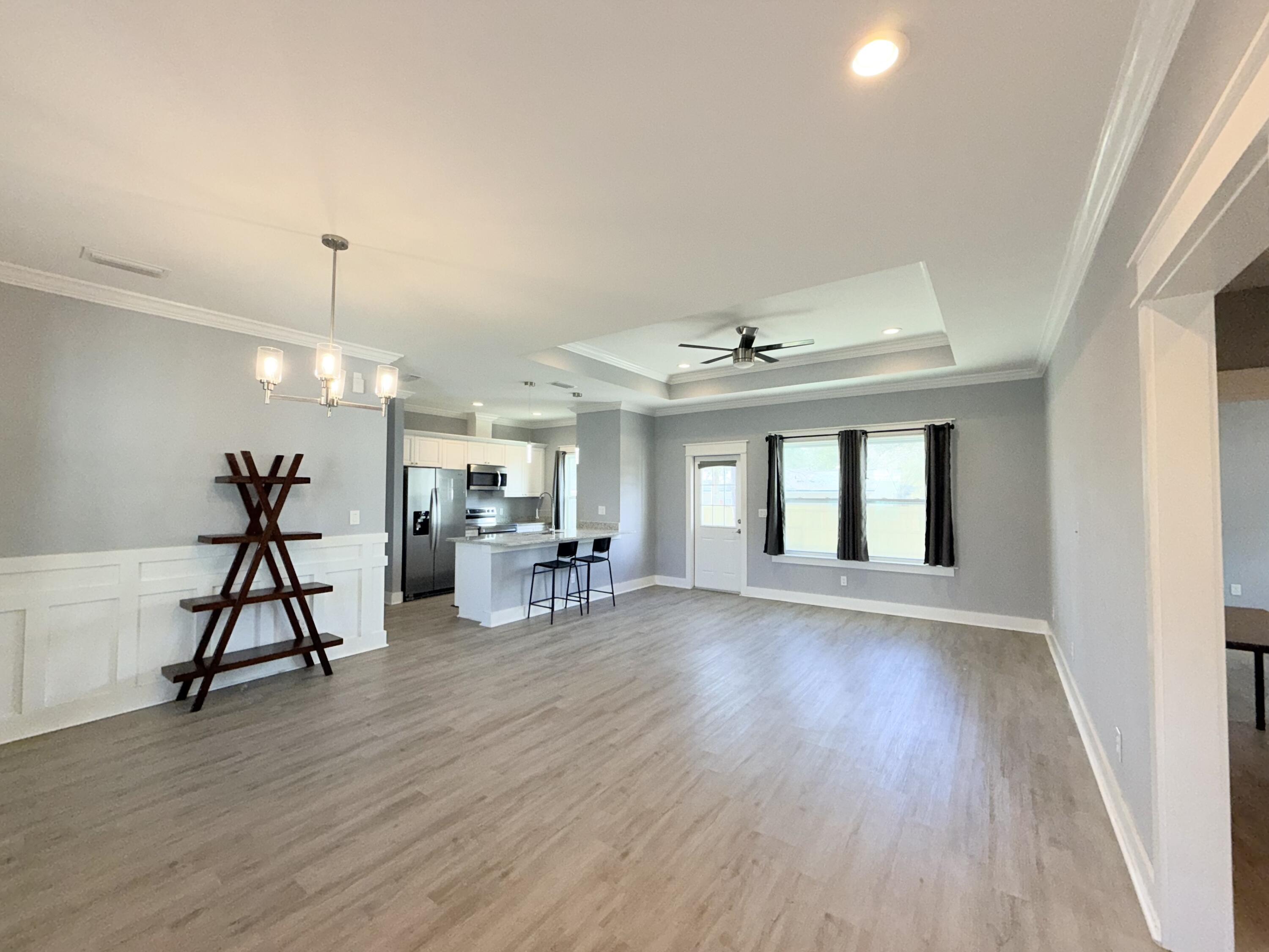 122 Loblolly Circle Midway, FL 32343 - Photo 4 of 38 a view of a livingroom with furniture wooden floor and a chandelier
