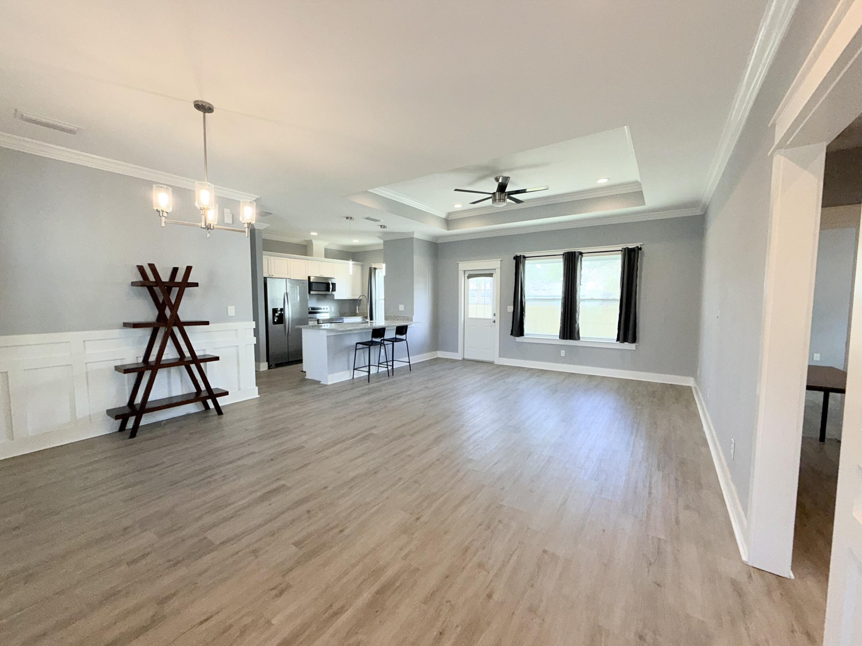 122 Loblolly Circle Midway, FL 32343 - Photo 5 of 38 a view of a livingroom with a furniture wooden floor and a chandelier