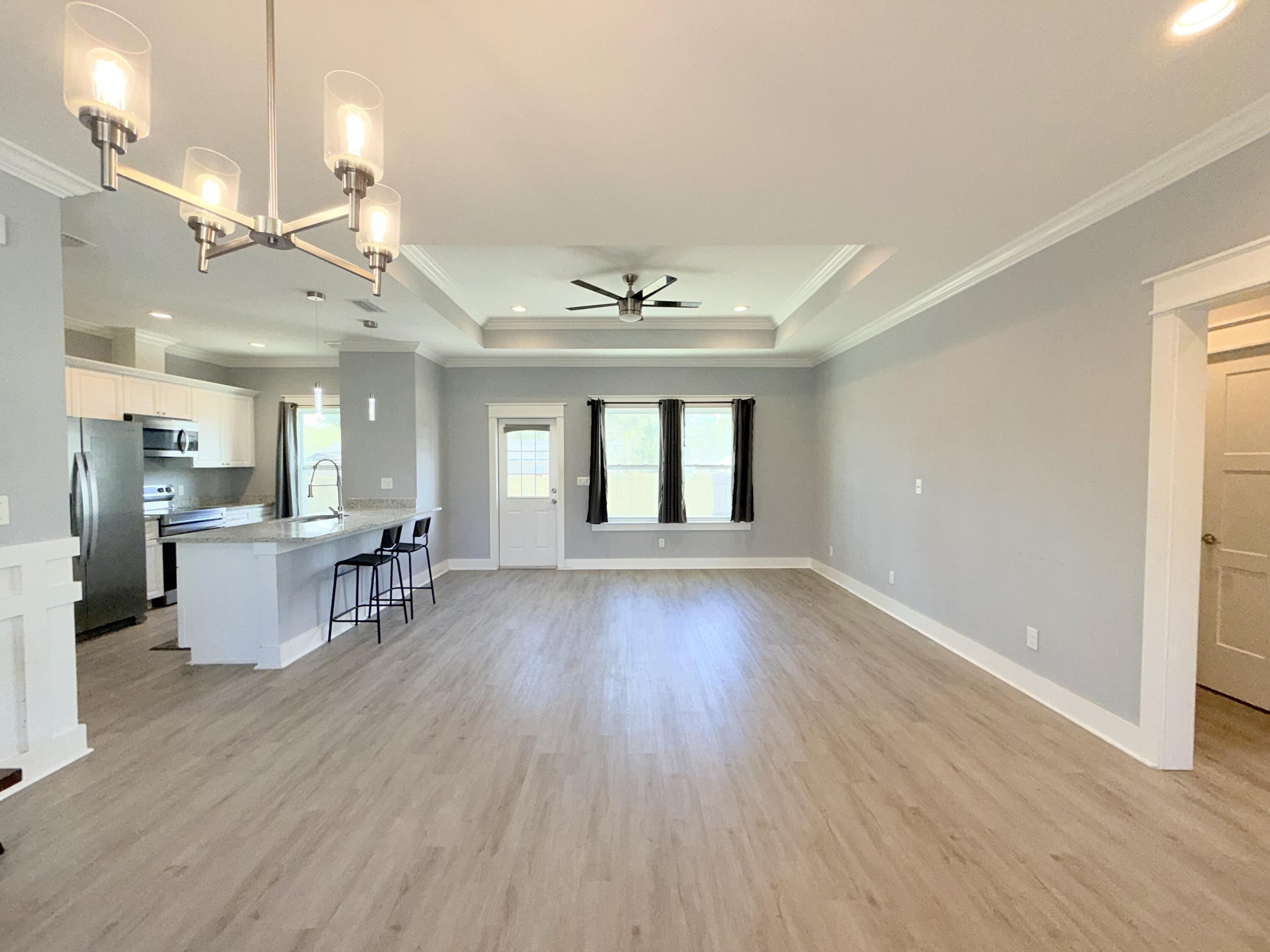 122 Loblolly Circle Midway, FL 32343 - Photo 6 of 38 a view of a living room and kitchen with a large window