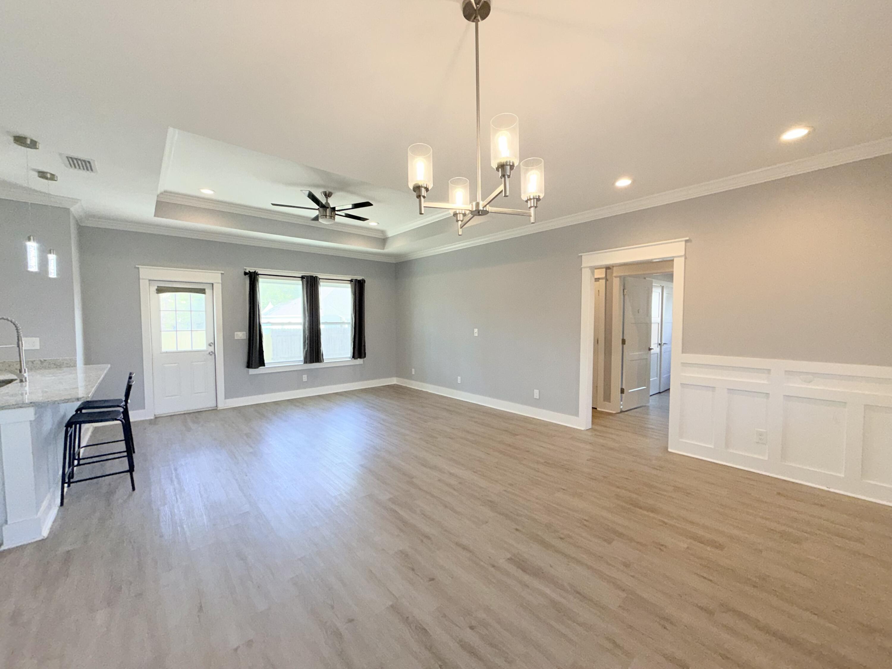 122 Loblolly Circle Midway, FL 32343 - Photo 7 of 38 a view of an empty room with wooden floor and a window