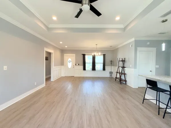 a view of an empty room and window with wooden floor