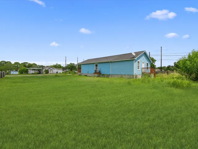 a backyard of a house with lots of green space and garden