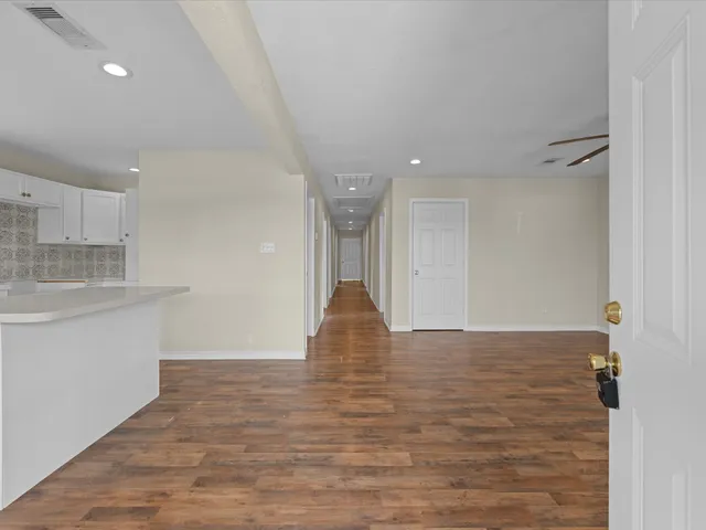 a view of a kitchen with a sink and cabinets