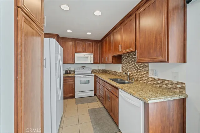 a kitchen with a sink stove and refrigerator